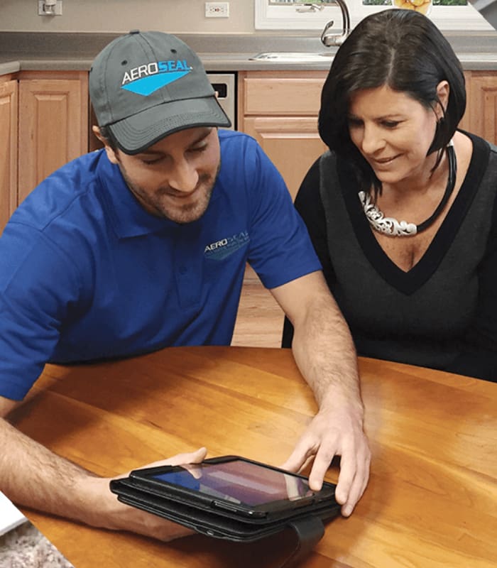 A man and woman looking at an ipad.