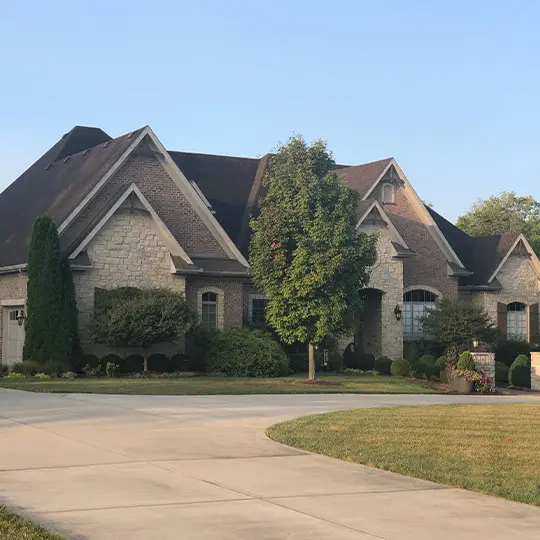 A large house with a driveway in front of it.