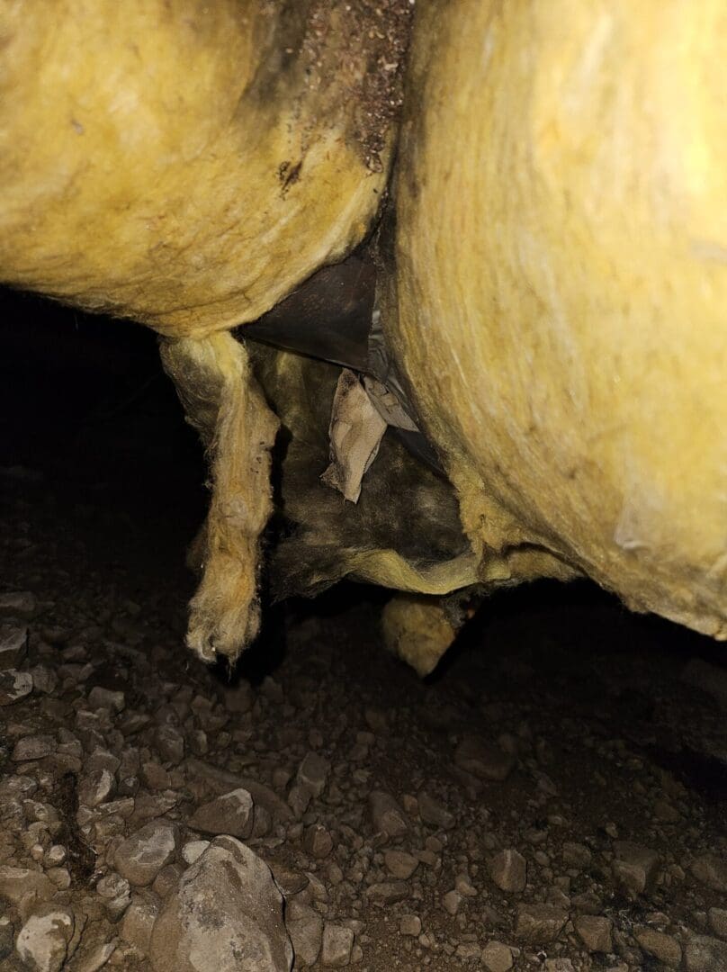 Black on the insulation indicates air leakage. White tape is asbestos-min